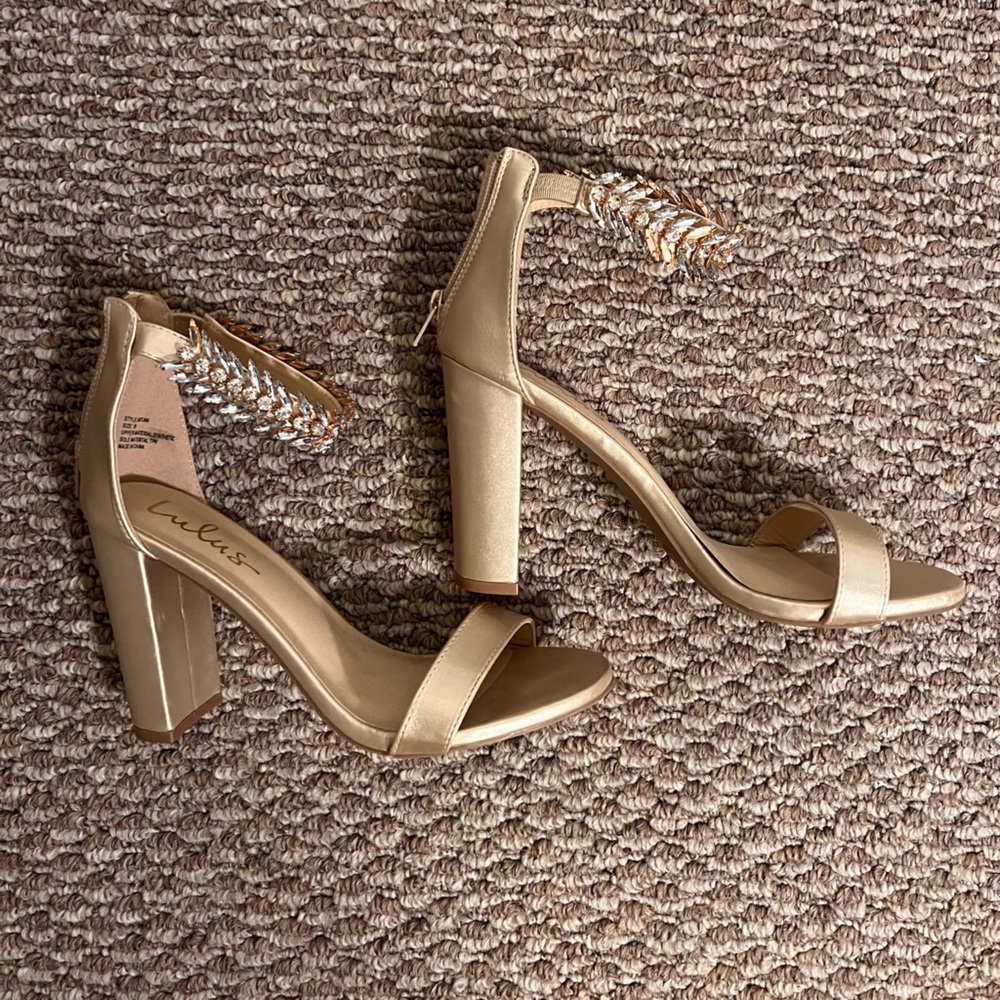Rarely worn Lulus gold ankle strapped heels.